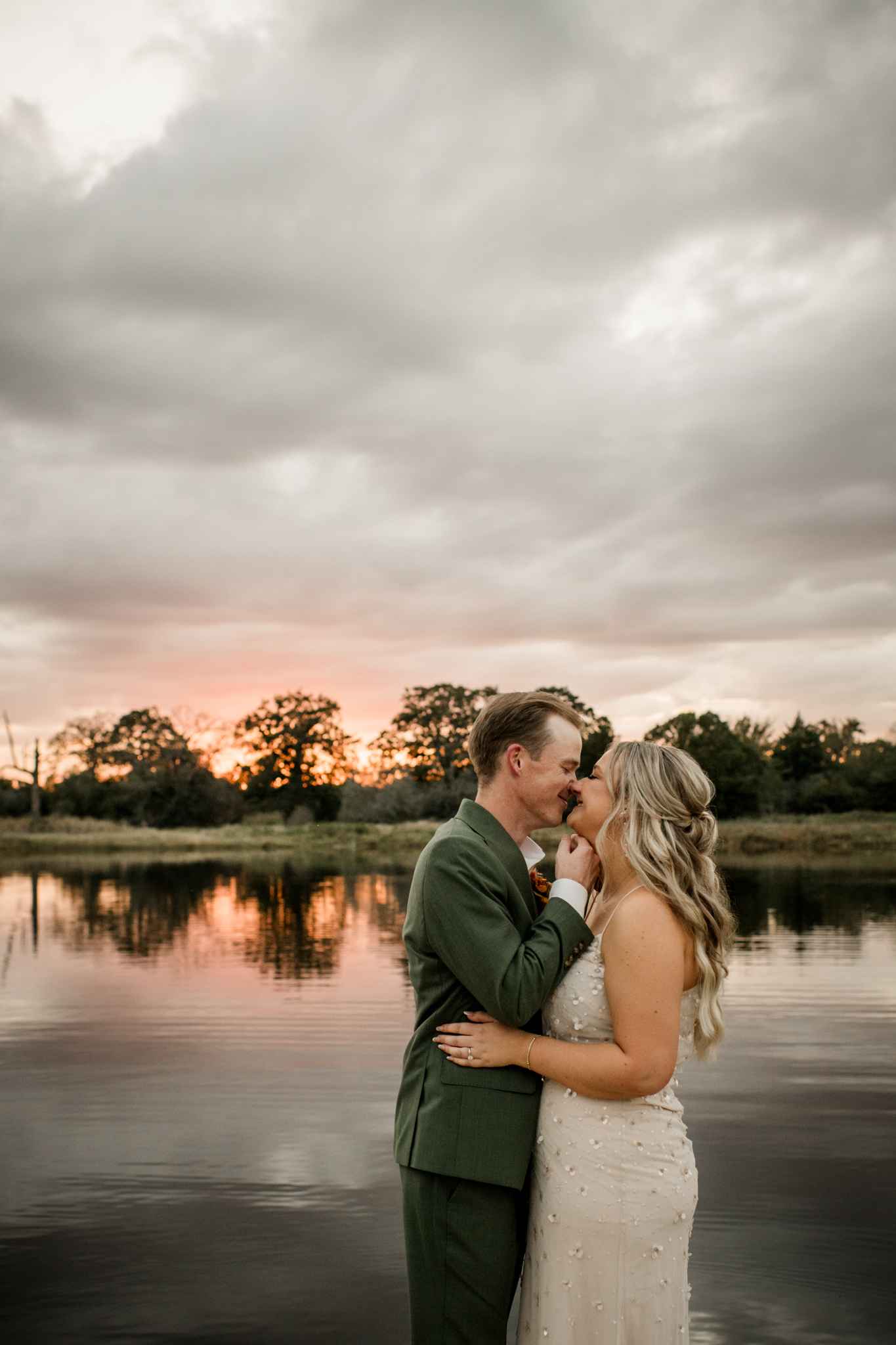 Groom dipping Bride in a black wedding dress standing in front of a massive fountain with Palms surrounding it at a Houston wedding venue by Jamie Hardin, photographer