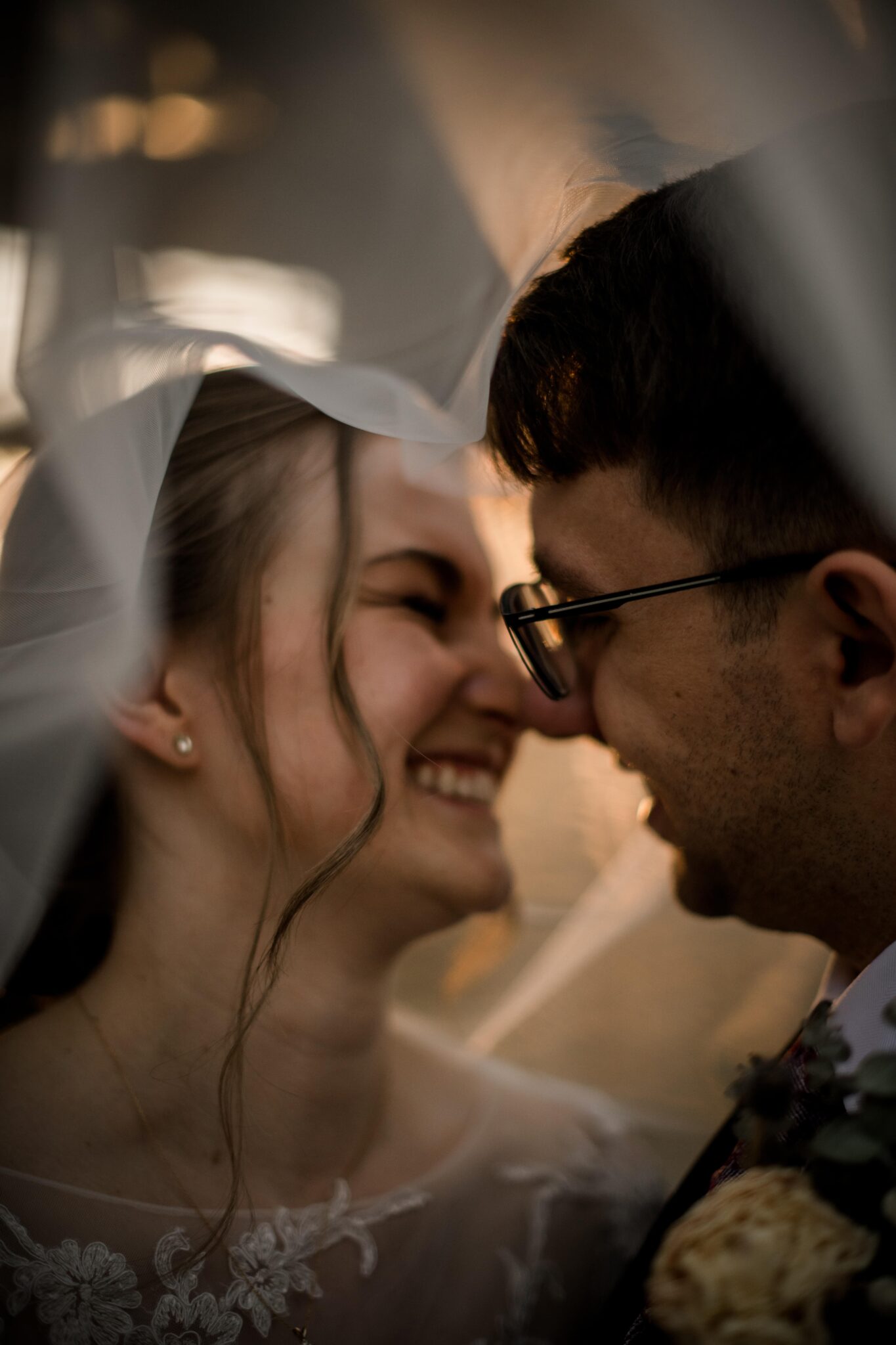 texas bride and groom are smiling at each other under the bride's veil.