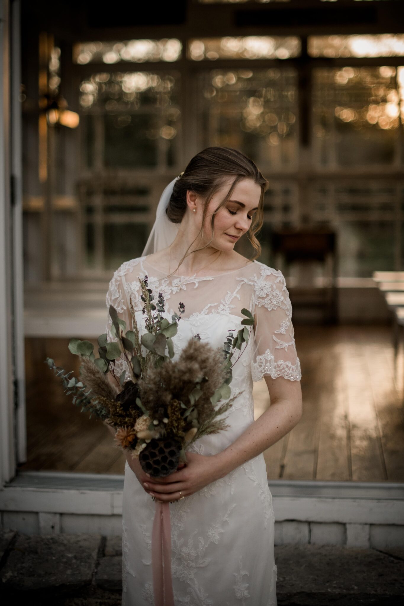 the texas bride is posing for bridal portraits in front of the 7F Lodge