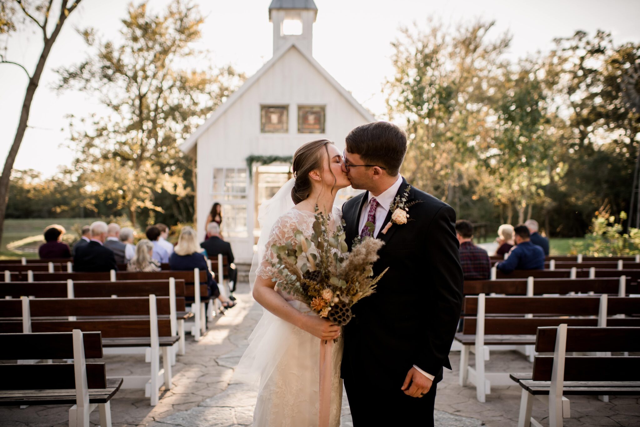 the texas bride and groom share their first kiss as newlyweds in golden hour at 7F Lodge