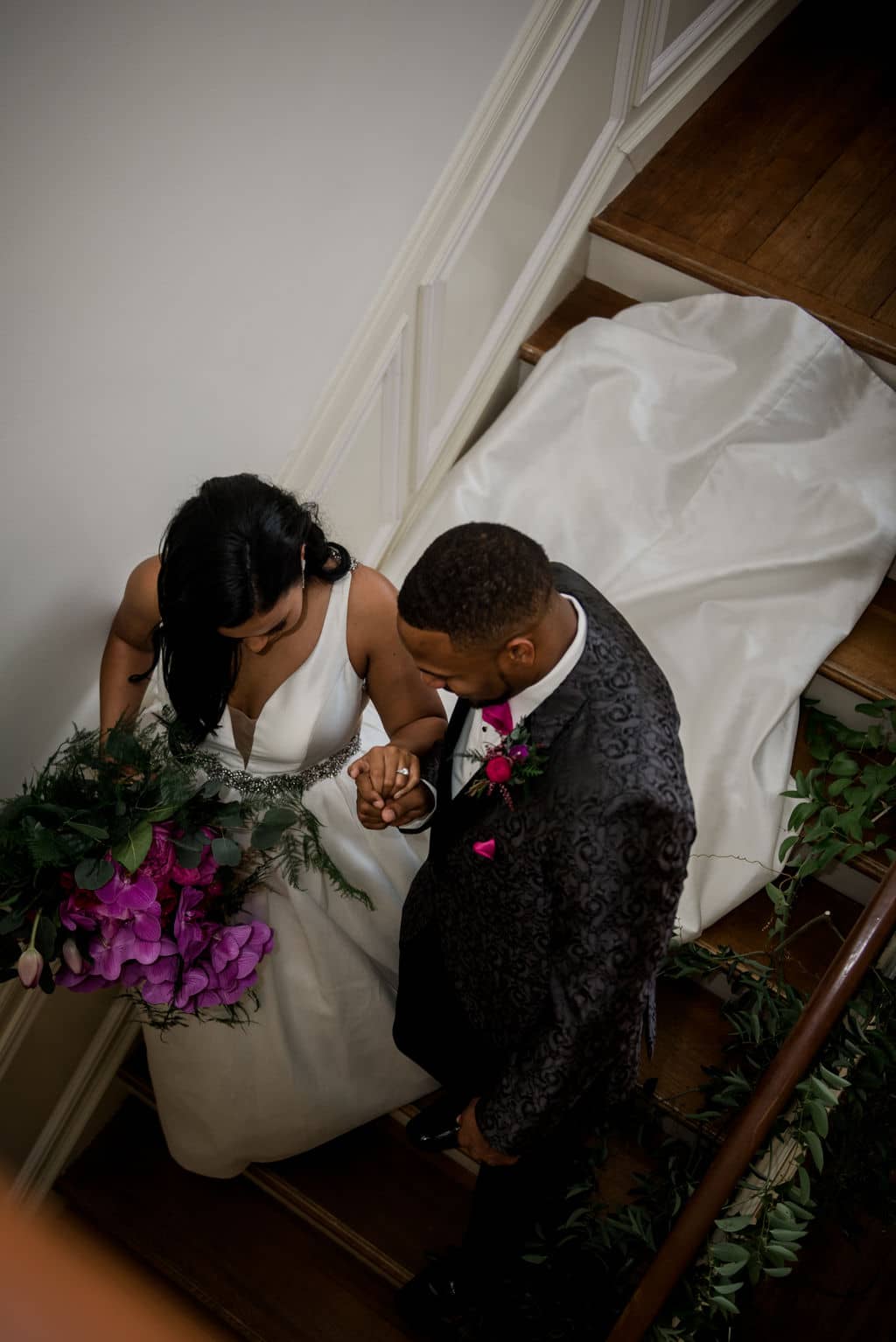 the texas bride and groom make their way down the staircase of the Astin Mansion