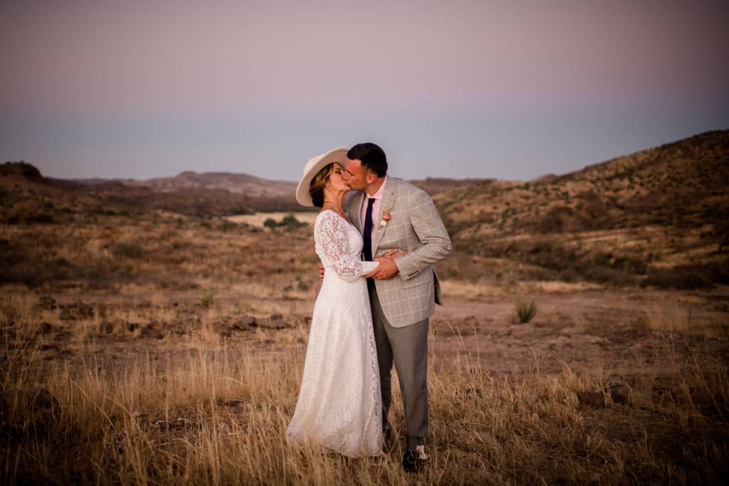 the bride and groom share a kiss at big bend national park after their texas elopement