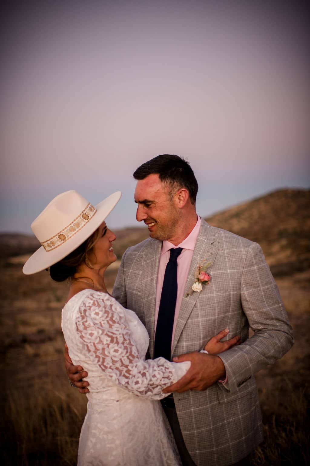 the bride and groom hug each other at texas's big bend national park