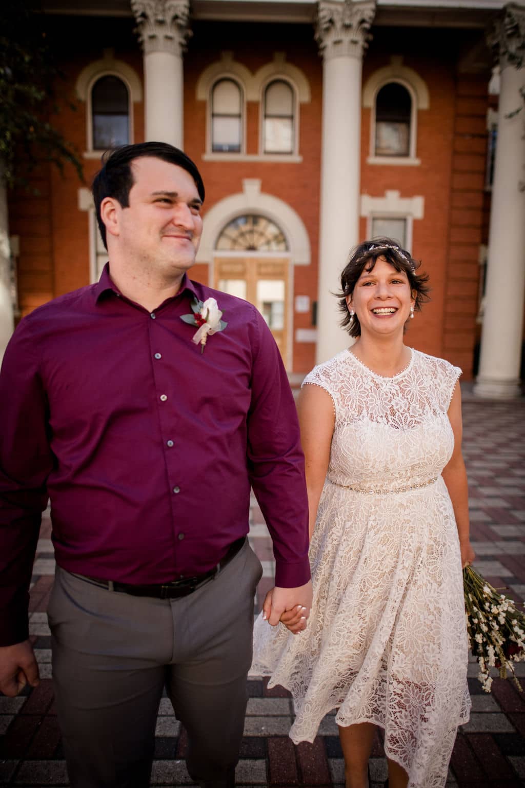 texas bride and groom pose in front of the brazos county courthouse as newlyweds