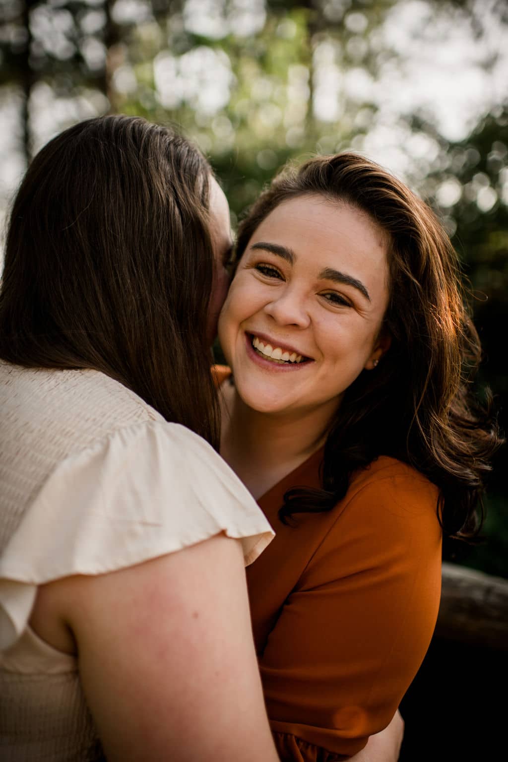 a bride kissing the other on the cheek at a bryan-college station wedding venue in an inclusive client experience