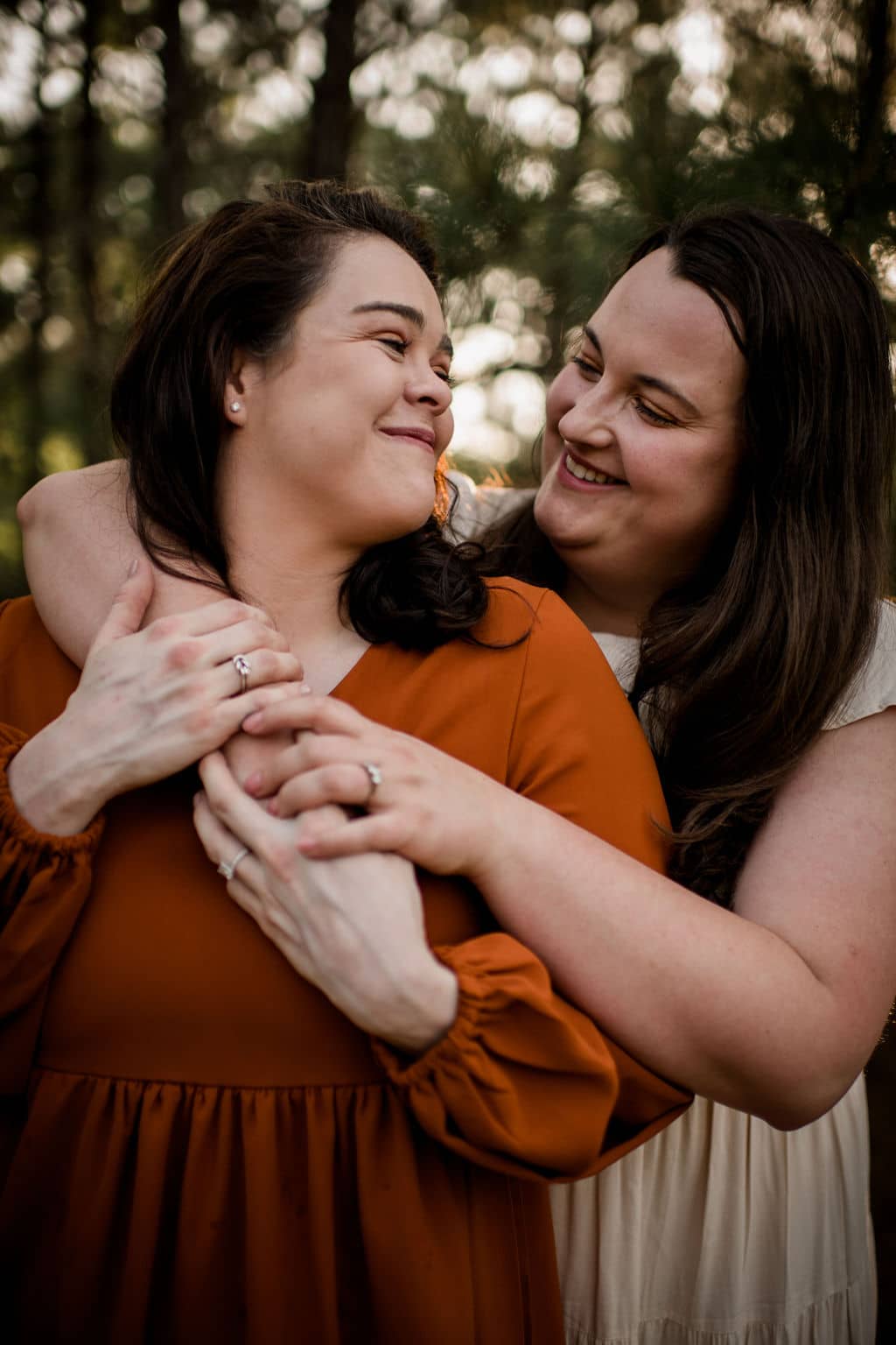 two brides holding hands and looking at each other with love at a bryan-college station wedding venue in an inclusive client experience