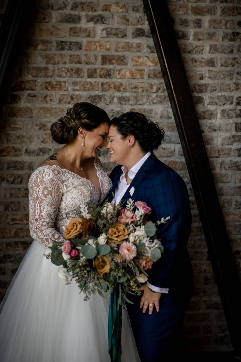 two brides foreheads touching in a bryan-college station wedding venue in an inclusive client experience