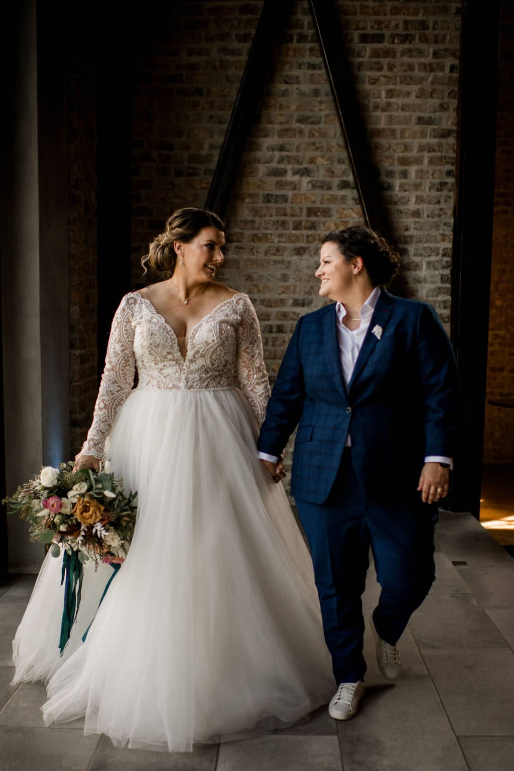 two brides walking down the bryan-college station wedding venue in an inclusive client experience