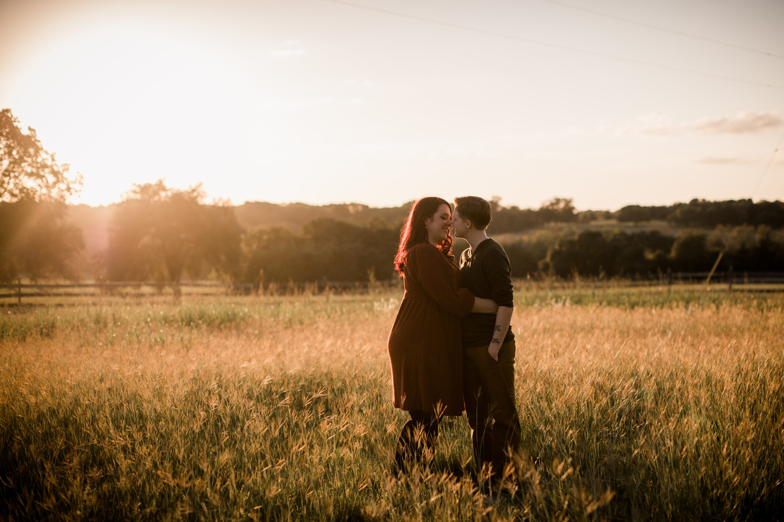 two brides in a field embracing each other at a bryan-college station wedding venue