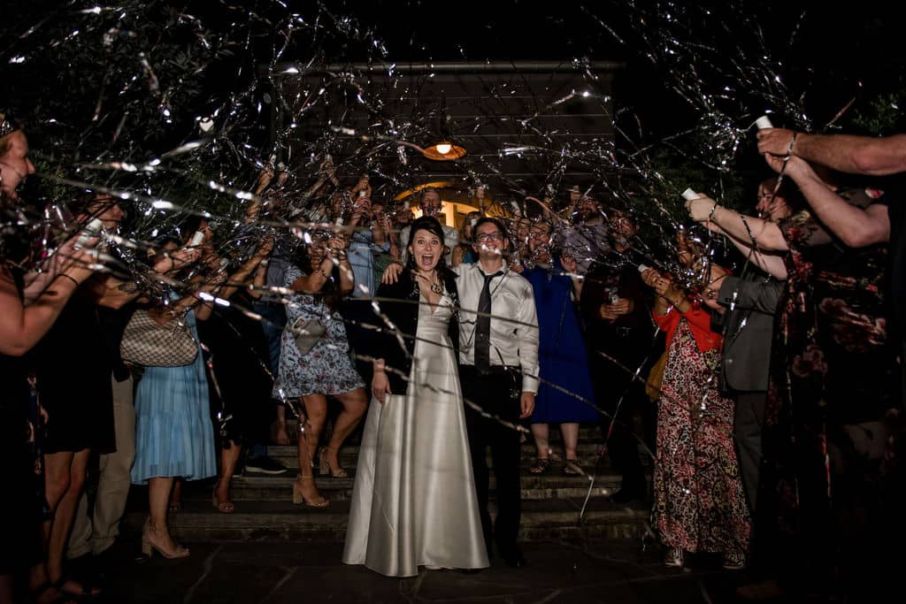 Peach Creek in Texas surrounded by ribbon wands as the bride and bride exit their wedding captured by Jamie Hardin Photography