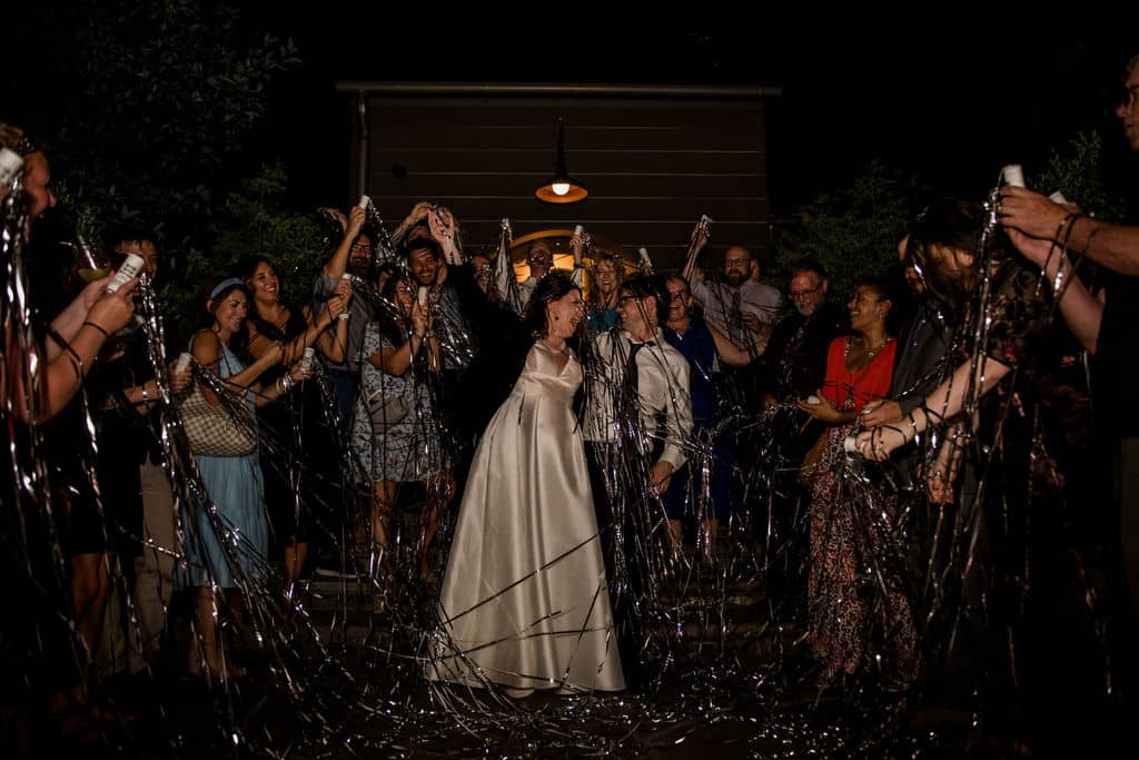 Peach Creek in Texas surrounded by ribbon wands as the bride and groom exit their wedding captured by Jamie Hardin Photography