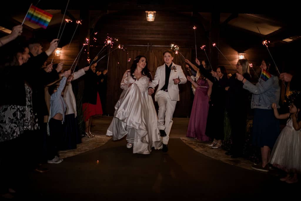 Peach Creek in Texas surrounded by sparklers as the bride and bride exit their wedding captured by Jamie Hardin Photography