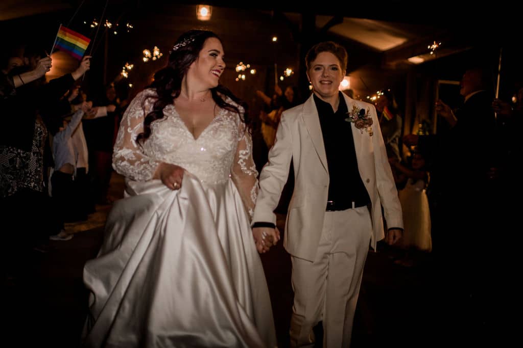 Peach Creek in Texas surrounded by sparklers as the bride and bride exit their wedding captured by Jamie Hardin Photography