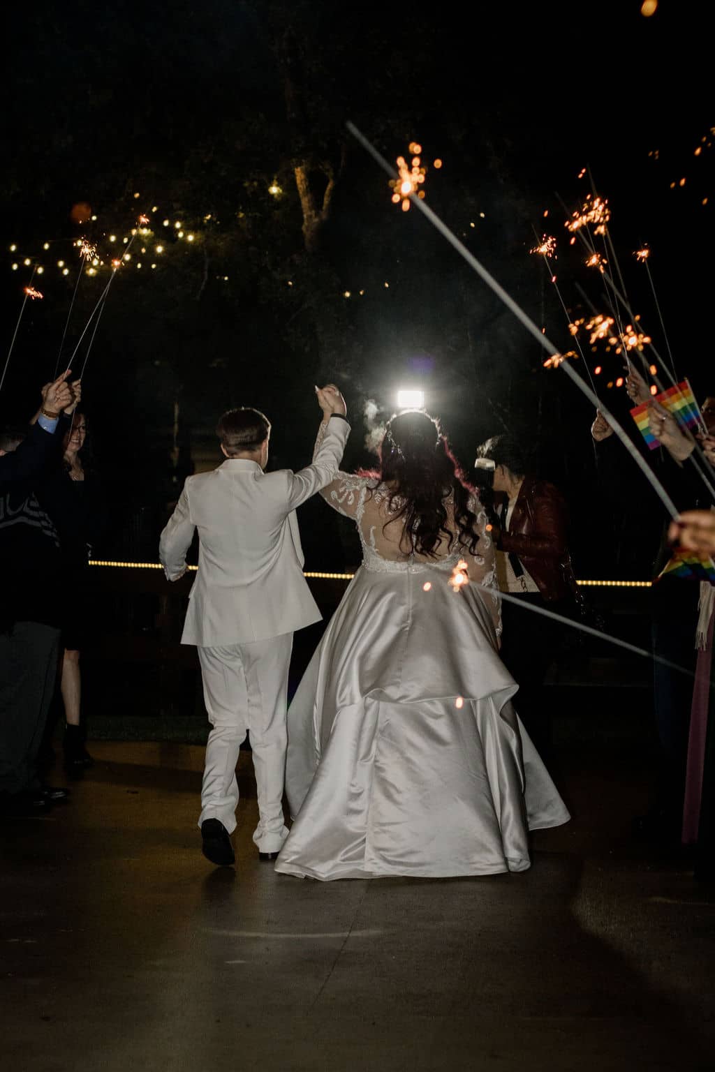 Peach Creek in Texas surrounded by sparklers as the bride and bride exit their wedding captured by Jamie Hardin Photography