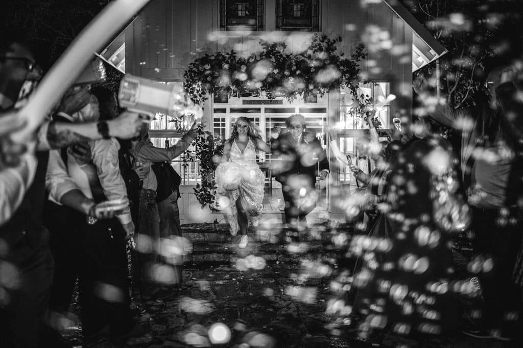 Bubbles blur the image at 7F Lodge in Texas as a unique wedding exit captured by Jamie Hardin Photography