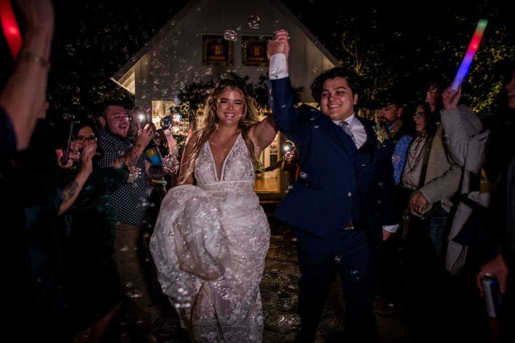 7F Lodge in Texas surrounded by bubbles as a unique wedding exit captured by Jamie Hardin Photography
