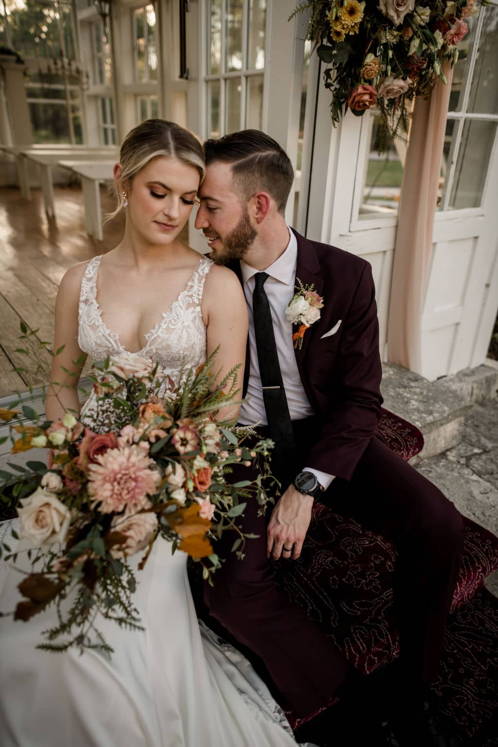 bride and groom sitting in the steps of 7F Lodge after their wedding ceremony