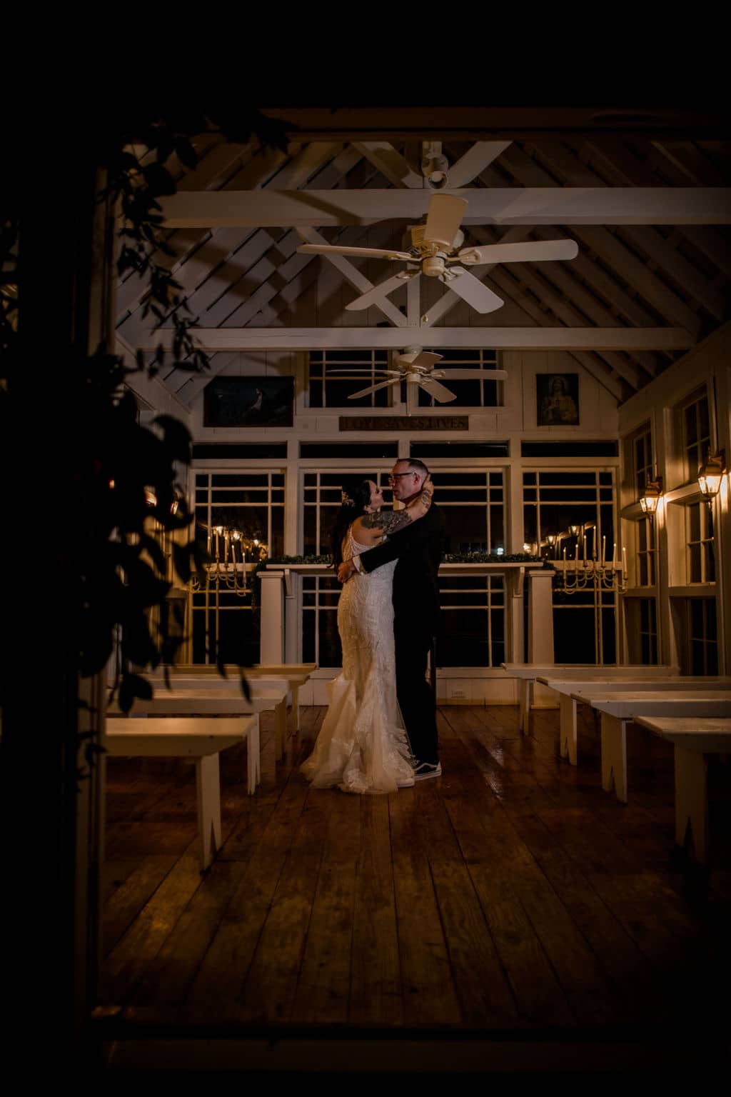 bride and groom dancing in the night inside the white chapel of 7F Lodge