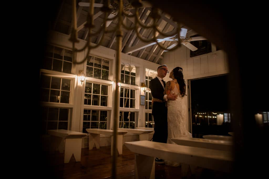 bride and groom dancing in the night inside the white chapel of 7F Lodge