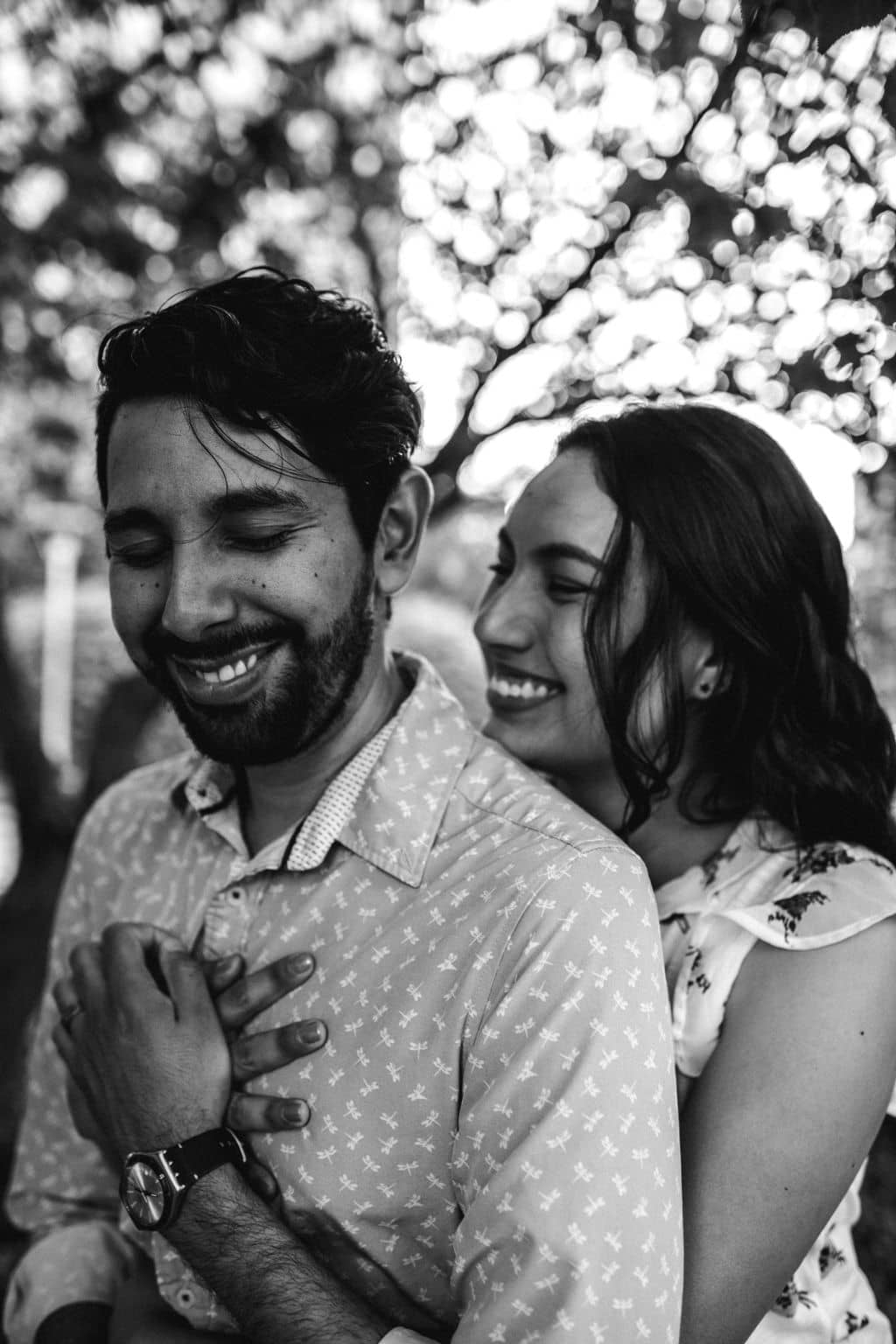 the future bride is holding her future groom in texas for their engagement photo outfits