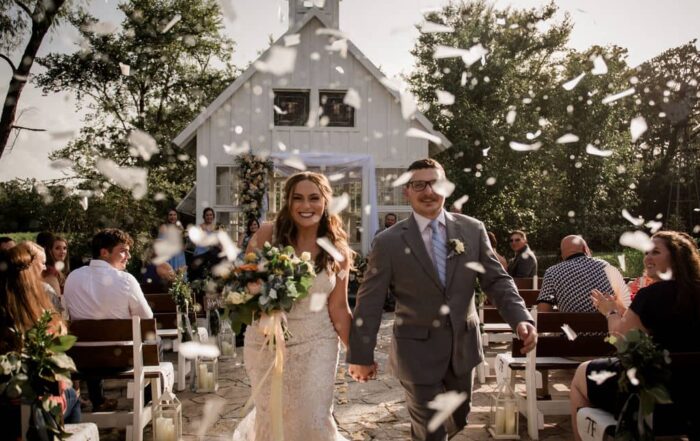 the bride and groom exiting their texas summer wedding with eco-friendly confetti