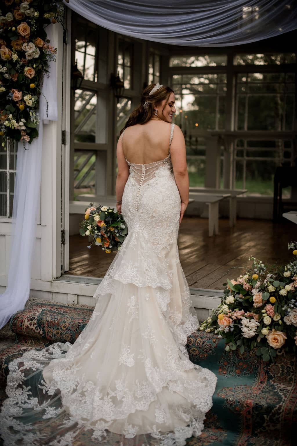 the texas bride is posed facing away from the camera to show off her white wedding dress at 7F lodge