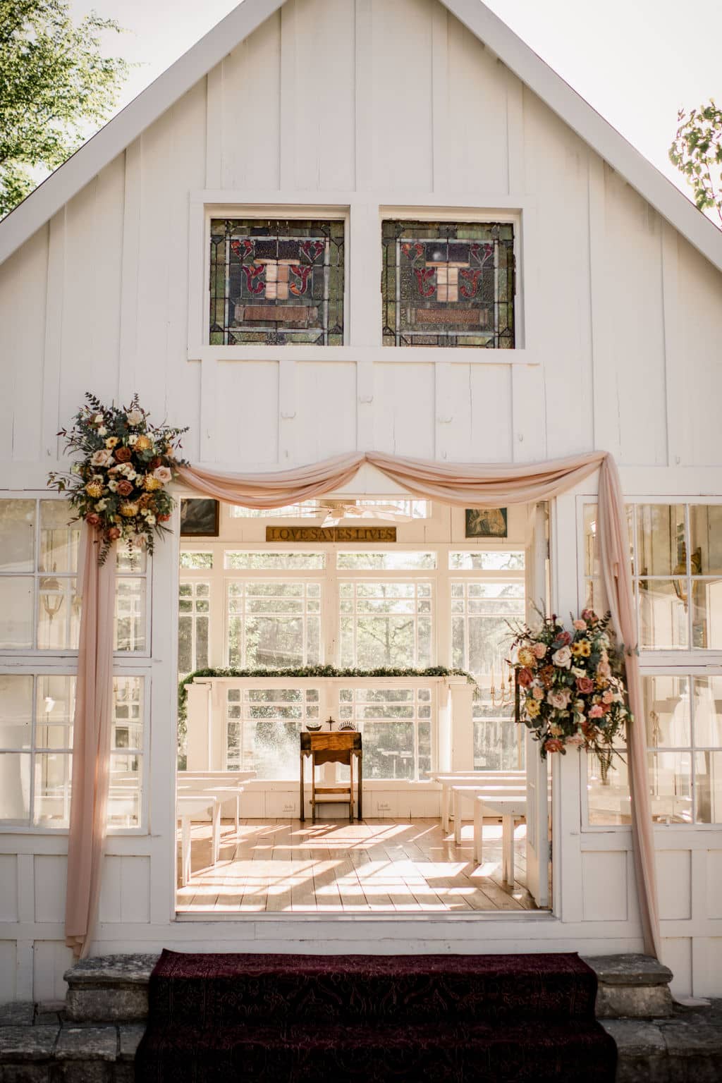 the white chapel of 7F lodge is decorated with floral designs by urban rubbish