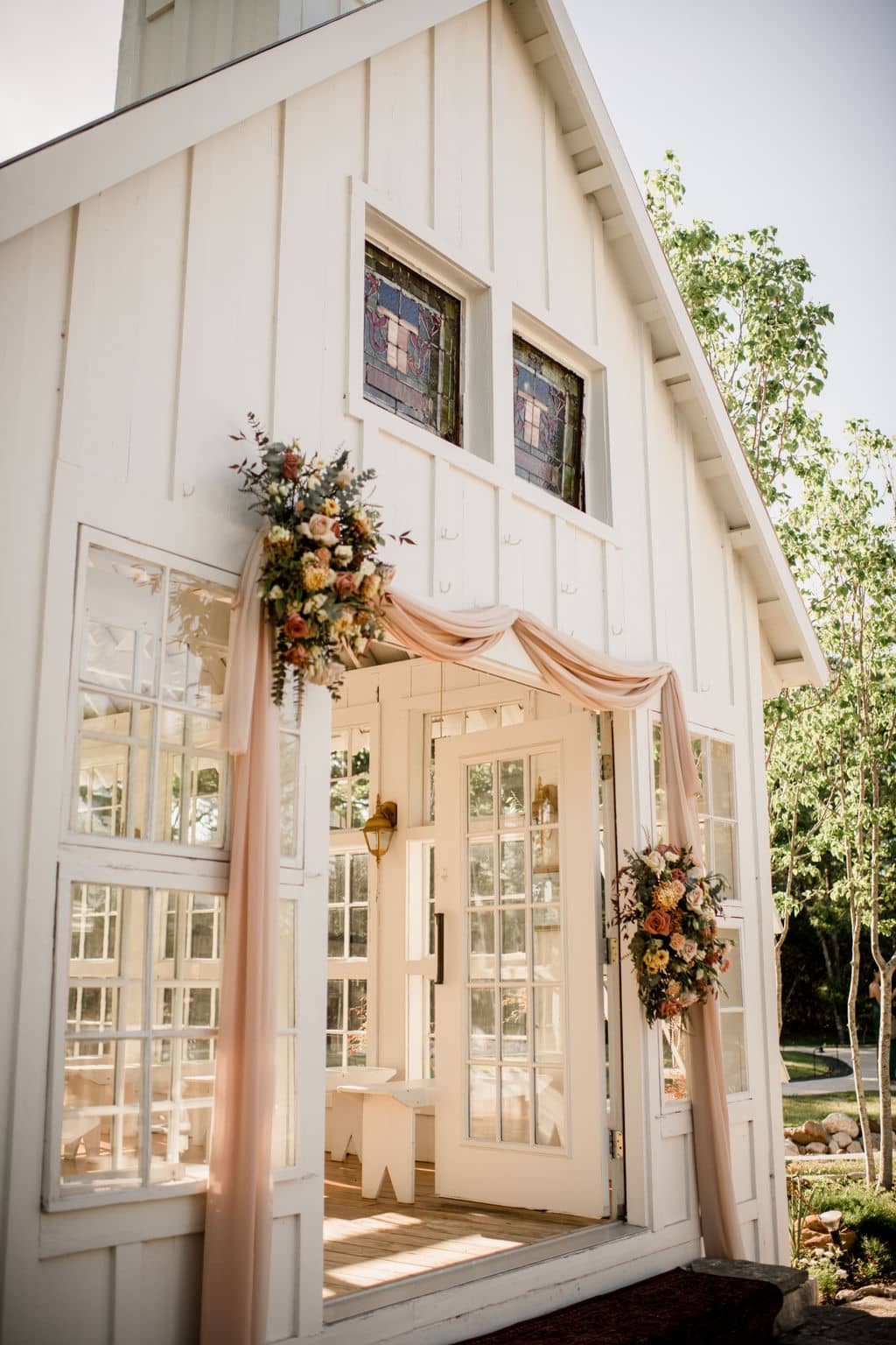 the white chapel at 7F Lodge is decorated with local vendor details after couple learned how to plan a wedding in bryan college station.