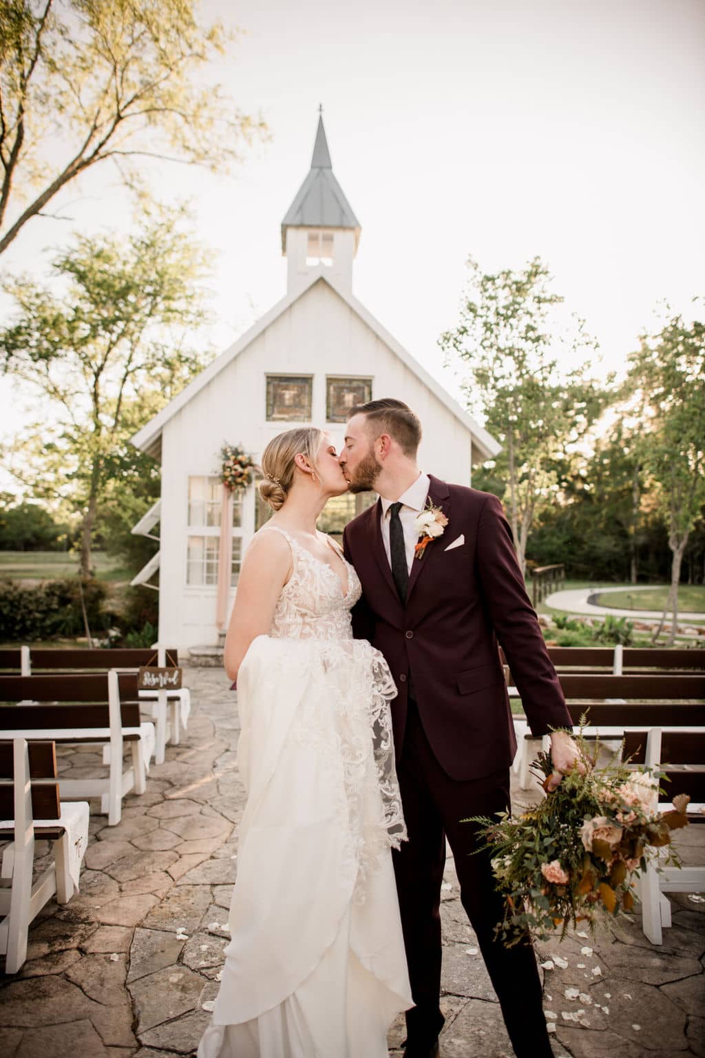 the bride and groom kiss at the end of the aisle after saying their vows at 7F lodge