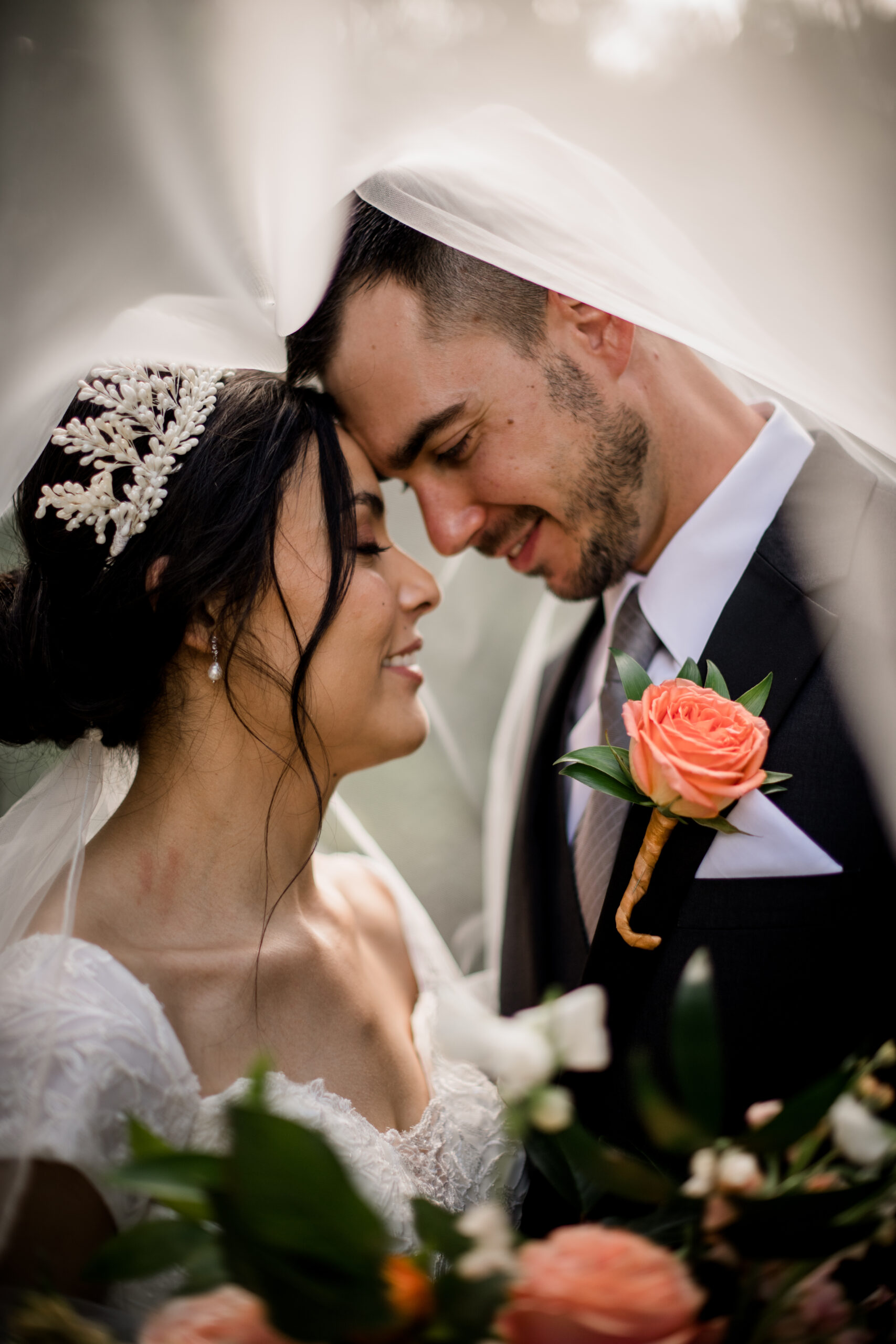 the texas bride and groom are engulfed in an etheral light coming from the bride's veil in summer