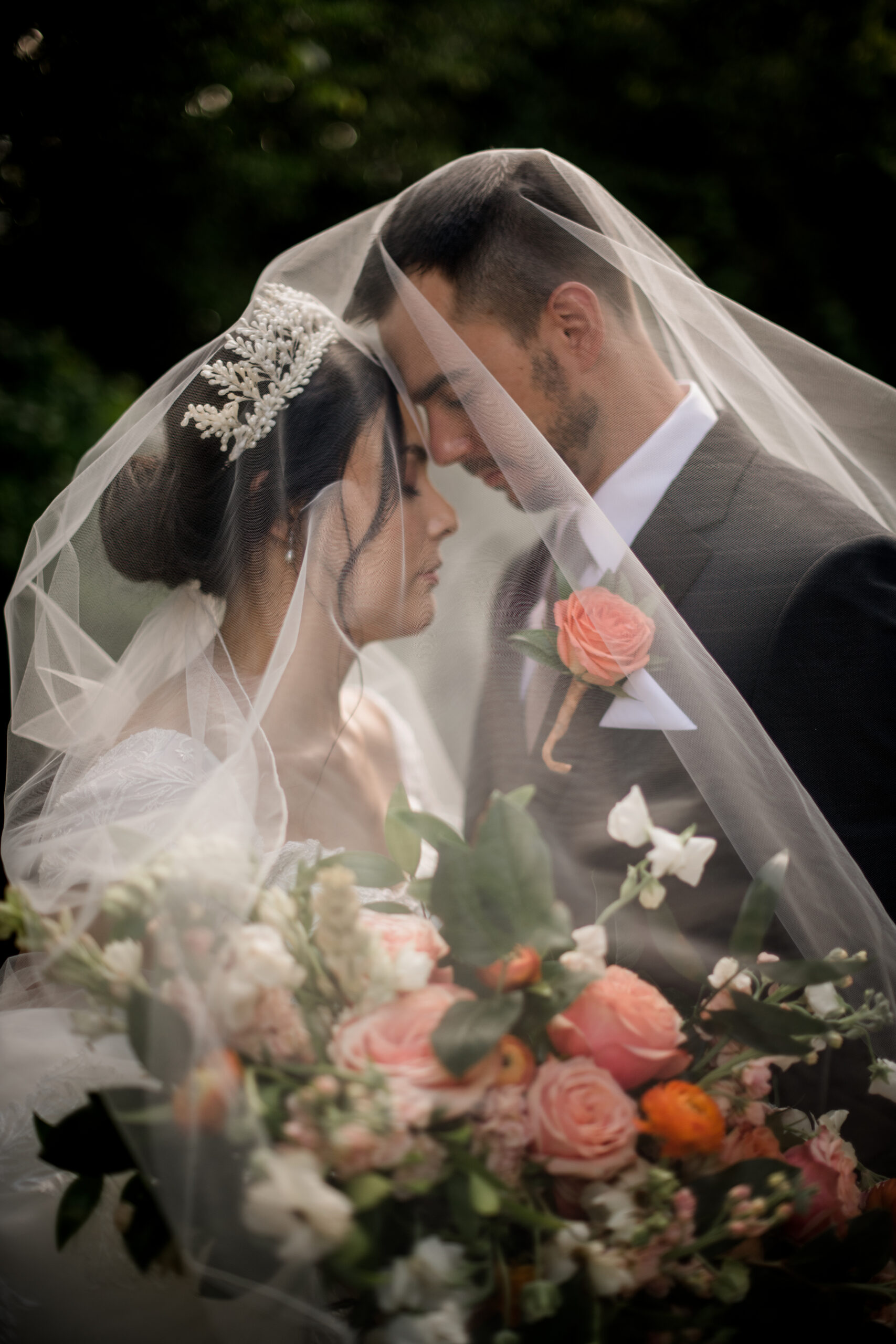 the texas bride and groom are engulfed in an etheral light coming from the bride's veil in summer