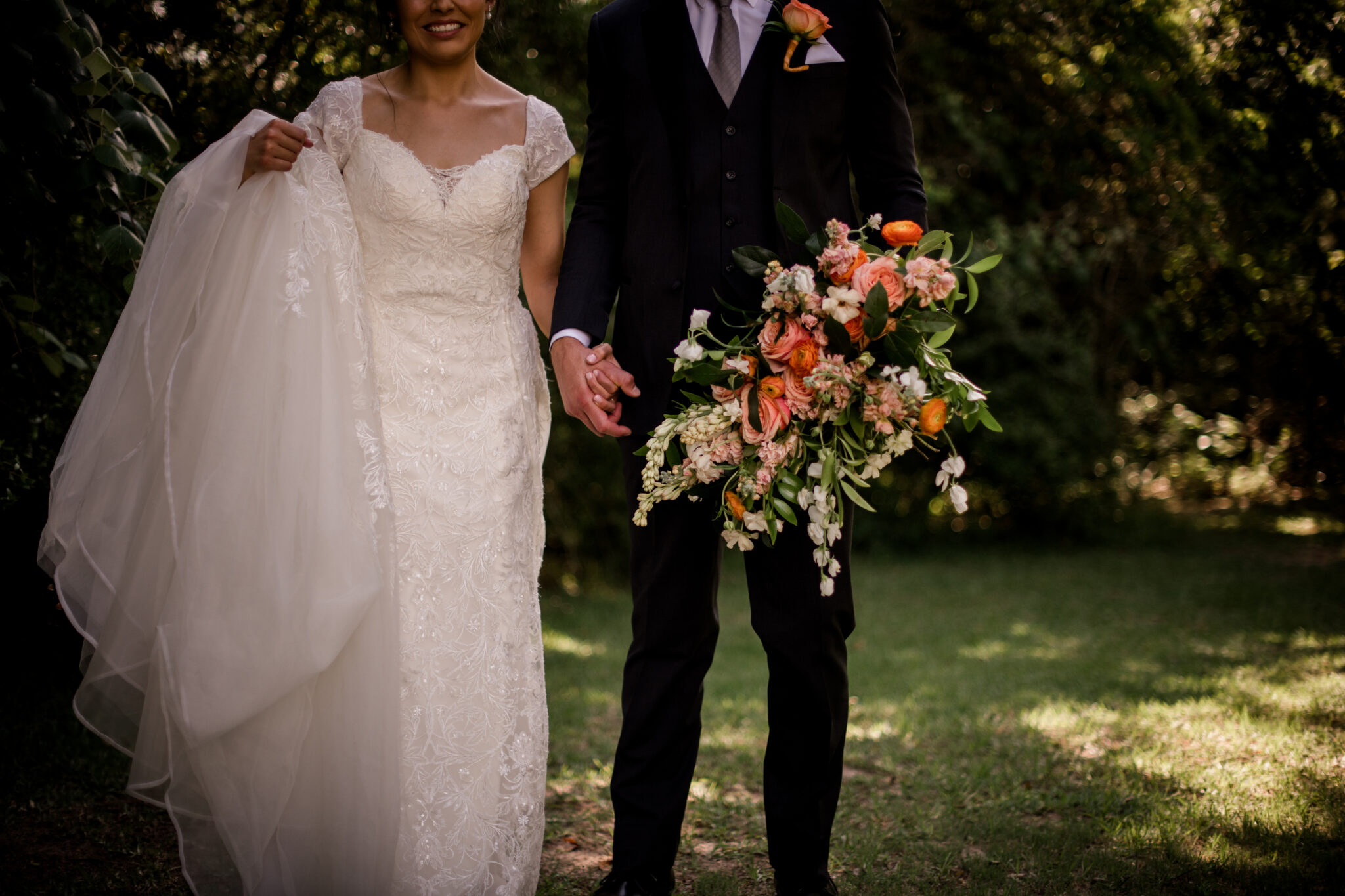 the texas bride and groom are walking hand in hand in the texas courtyard