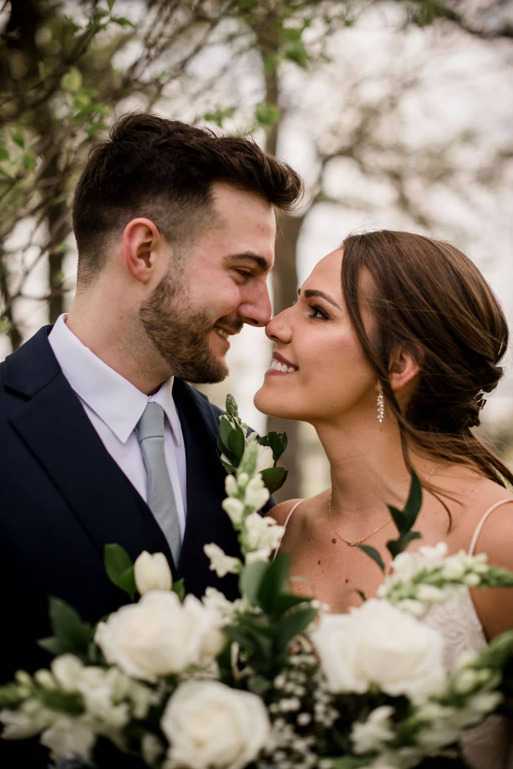 texas bride and groom are touching noses for their couple's portraits on their wedding day kin the bryan college station area