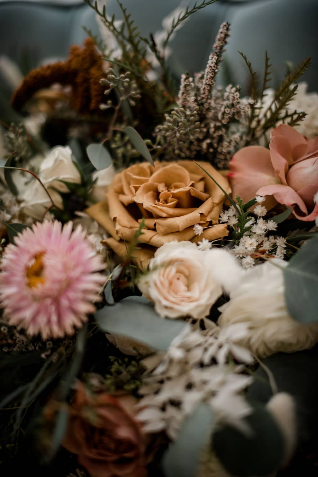 this texas bride's wedding bouquet is made from a mixture of seasonal flowers in Texas. A mixture of red, yellow, pink, and white florals selected by the texas wedding florist