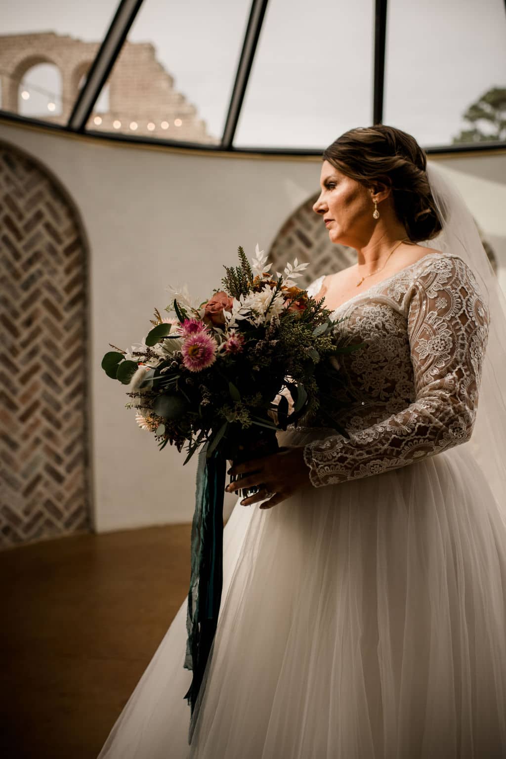 texas bride in her white wedding gown hoolding a floral arrangement by texas wedding florist urban rubbish
