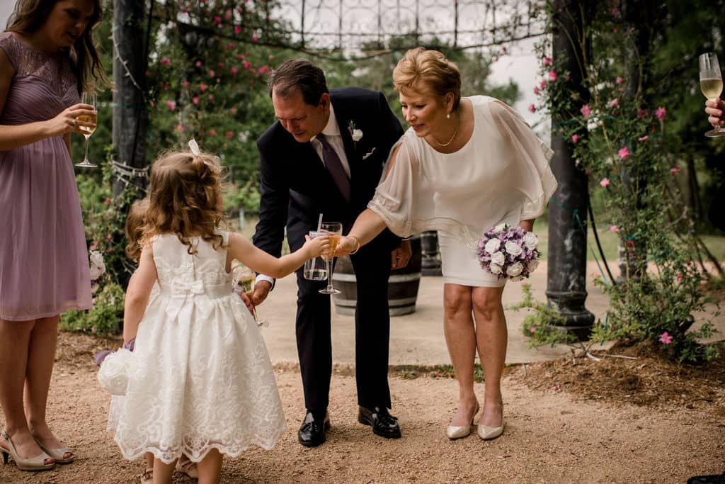 the husband and wife cheers with their grand daughter after their vow renewal ceremony