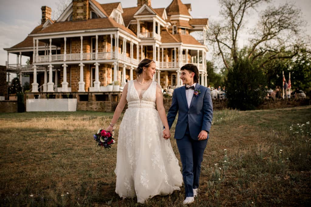 the texas brides walk away from their venue holding handss captured on a photographer must haves tool