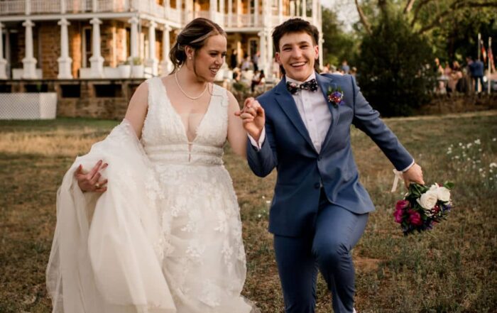 the texas brides walking away from their venue as they jump in the air captured using a photographer must haves tool