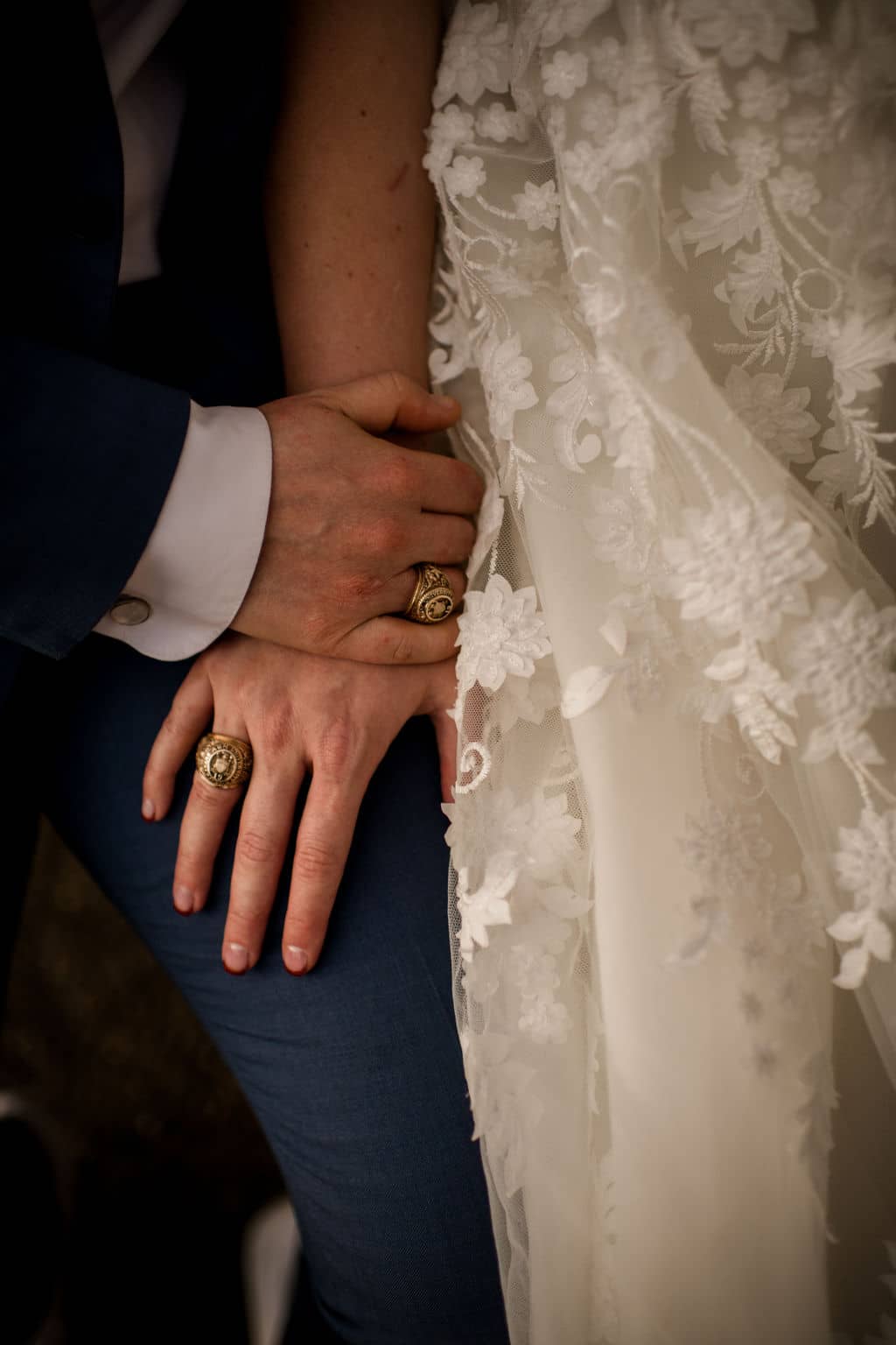 the two texas brides hold onto each other's hands dressed in a blue suit and white dress captured on a photographer must haves tool